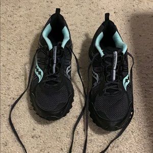 Black and mint green Saucony running shoes